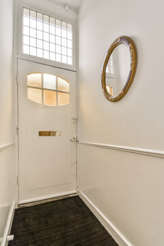 Elegant entrance with white door and decorative mirror