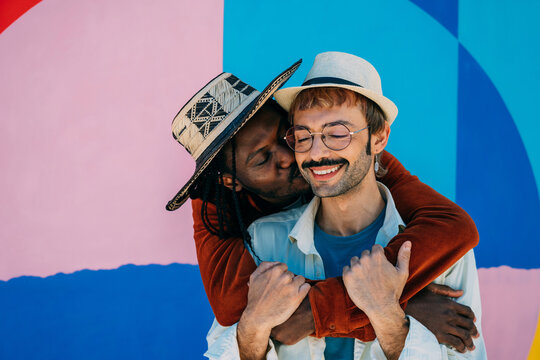 Joyful moment between gay multiethnic couple in city - Powered by Adobe
