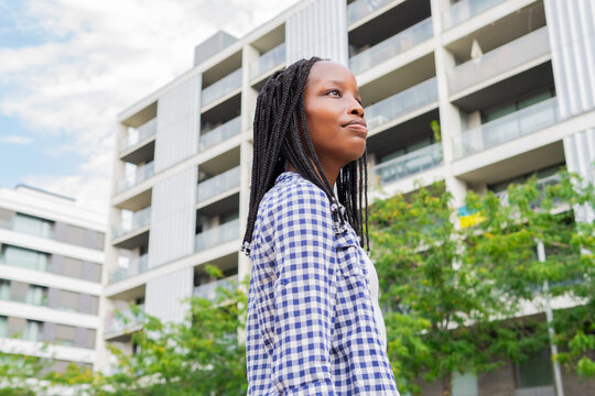 Black woman contemplating in a modern urban setting