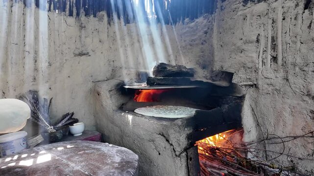 preparing bread in a traditional Dagestan village bakery. Bread is a flatbread baked in a Koryuk oven, common in the cuisine of the North Caucasus.