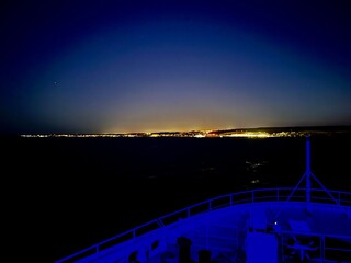 Beautiful sunset over the sea in Gozo seashore, Malta with the view on seashore with early city...