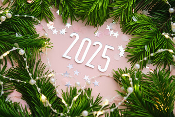 New Year 2025 pink background. Number of the coming year in Christmas decoration.