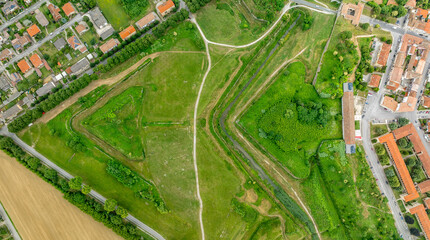 Aerial view of fort military architecture: lunette in front of a bulwark, bastion connected by...