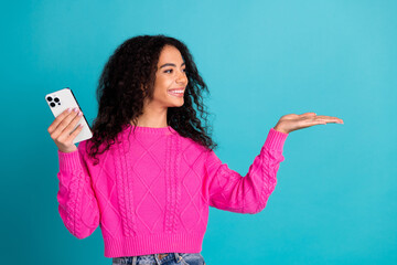 Photo portrait of attractive teen girl hold device look empty space dressed stylish pink clothes...