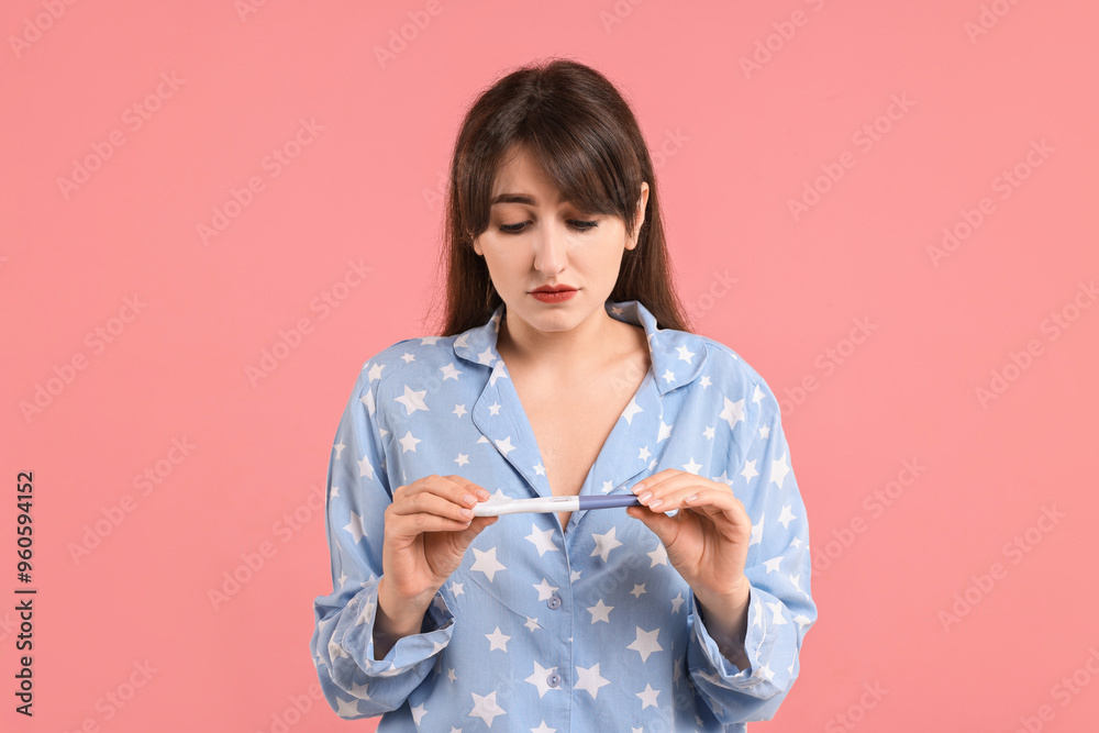 Canvas Prints Worried young woman with pregnancy test on pink background