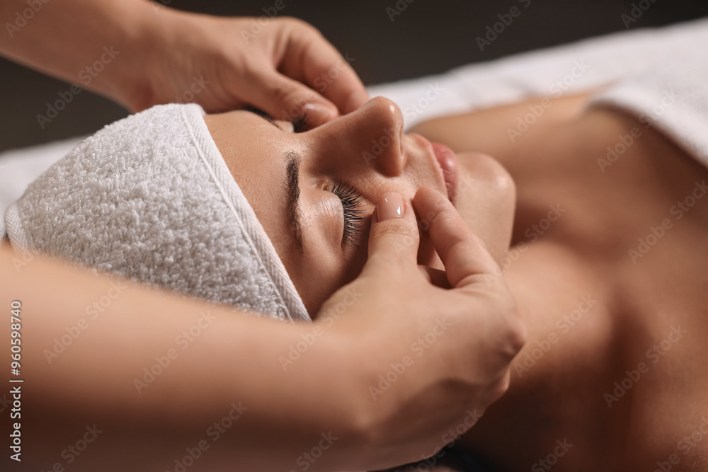 Wall mural Attractive woman enjoying face massage, closeup. Beauty procedure