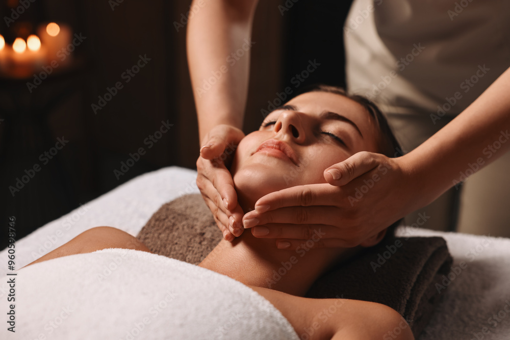 Wall mural Attractive woman enjoying face massage, closeup. Beauty procedure