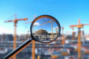 Magnifying glass construction inspection, quality control or searching for real estate business opportunities