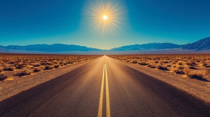 A straight, desert road stretching endlessly ahead, with distant mountains on the horizon and the sun high in the sky.