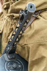 Shpagin submachine gun in the hands of a soldier close-up. Firearms from the Second World War.