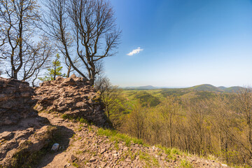 Beautiful green landscape of Walbrzych mountains with blue sky seen from top of Rogowiec mountain 870 meters above the sea level with ruins of old castle