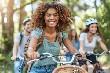 Obraz premium A group of adventurous friends joyfully riding their bikes through a beautiful forest trail