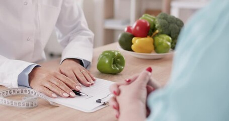 In a close up shot of a hands of a nutritionist doctor giving advice to a patient during a consultation. Making dietary plan, personalized care and guidance during the hospital visit.