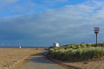 Empty beach during the off-peak season with the lifeguard building in the distance in Skegness UK