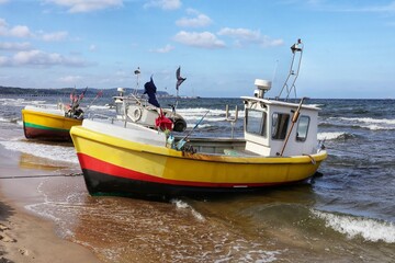 Two fishing boats on the shore of the Baltic Sea.