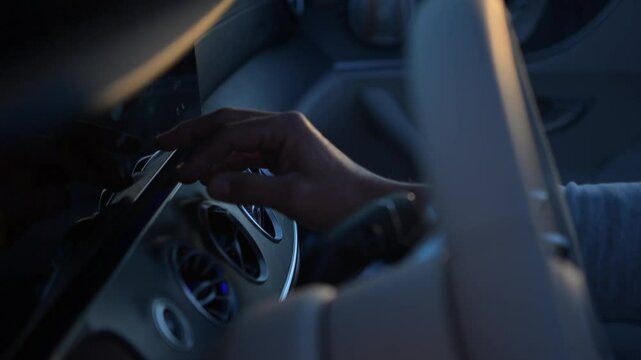 Adjusting the Car Controls at Dusk in an Urban Setting