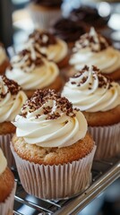 Chocolate Cupcake with Creamy Vanilla Frosting - A delectable chocolate cupcake topped with rich vanilla frosting and chocolate shavings, presented in a bakery display setting.