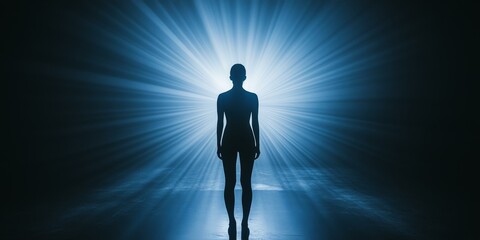 A silhouette of a woman standing in a blue light.