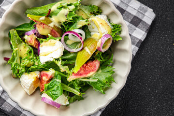 fig salad green lettuce, figs, soft cheese fresh meal food snack on the table copy space food background rustic top view 