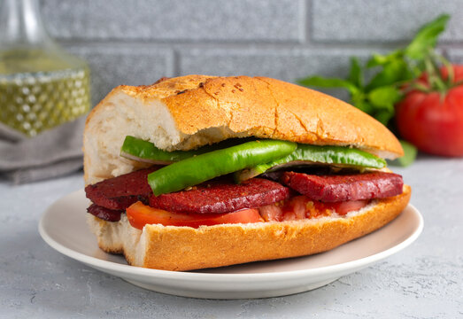 Sausage with bread on a wooden background. Turkish name; Sucuk ekmek - ekmek arası sucuk