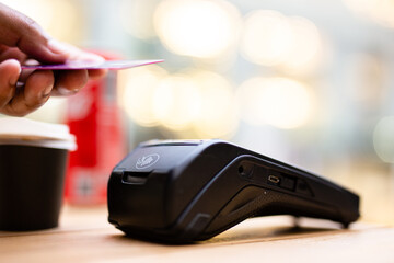 Customer paying with mobile phone in a bar