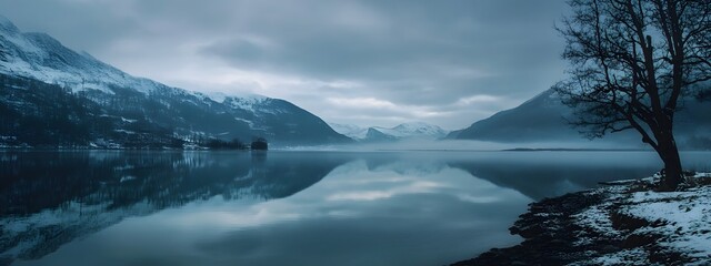 Fototapeta premium A cinematic still of snow-covered mountains reflecting in the calm waters, creating an ethereal and serene atmosphere