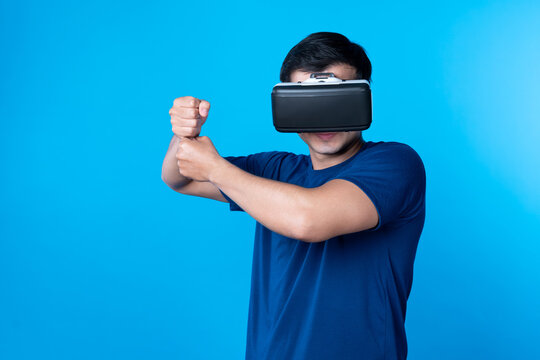 Smart gaming player wearing VR glasses playing sword or baseball team hologram isolated blue background screen connecting digital futuristic technology virtual reality in metaverse world. Contrivance.