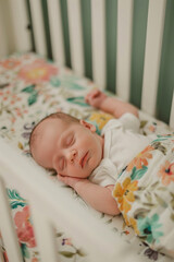 Close-up of a newborn baby sleeping peacefully in a cozy crib at home