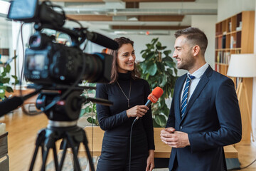 Businessman Being Interviewed by Journalist for Media Show: Broadcasting Success and Insights"