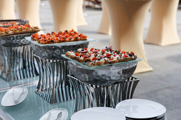 Trays with premium appetizers and aperitifs at an event with expensive catering and a chef