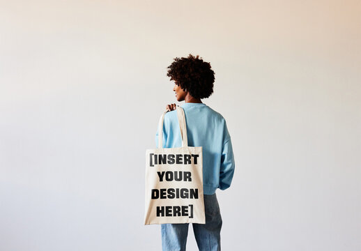 Mockup Of Woman With Afro Hair Looking Sideways Holding Tote Back Over The Shoulder. 