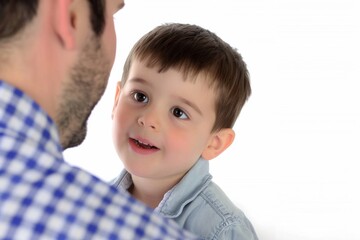 Obraz premium A touching moment between a little boy and his father captured against a bright white background during a joyful family day