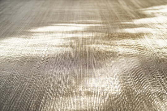 A bright textured surface with a subtle, linear texture, featuring fine, parallel lines that catch and reflect light dynamically.