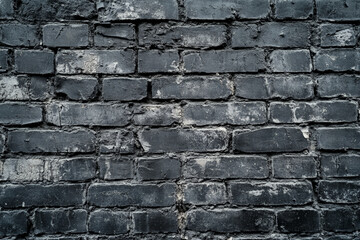 Naklejka premium A textured, dark gray brick wall with visible cracks and rough surfaces, creating a gritty, industrial feel.