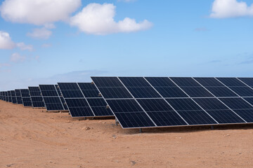 Vast solar panel array under clear blue sky