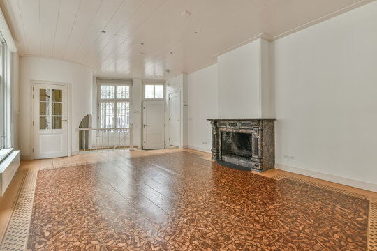 Spacious empty room with fireplace and unique flooring
