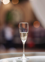 glass of sparkling wine on glass table. glass with prosecco wine in a restaurant. 