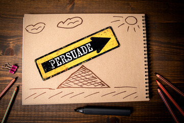 Persuade. Yellow arrow with text. Office desk