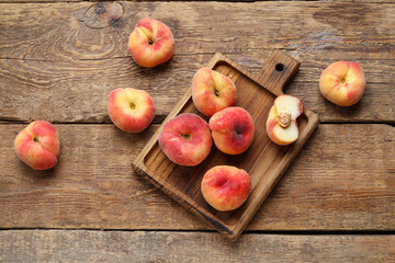 Board with sweet fig peaches on wooden background