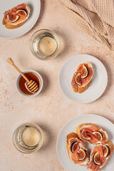 Food photography of bruschetta, toast with soft cheese, prosciutto and fig, honey, white wine, drink, beverage, breakfast, background