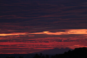 Fototapeta premium A beautiful red sunrise on the shores of the lake
