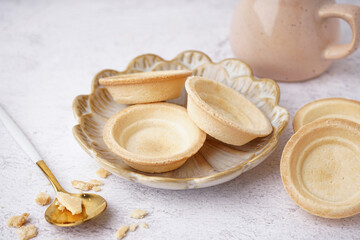 Plate with homemade tartlets on white background