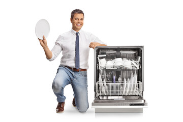 Happy man holding a clean plate from a dishwasher