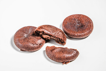 Dried chocolate pieces with melted chocolate filling on a white background. Chocolate bar. Pastry. snack concept close up.