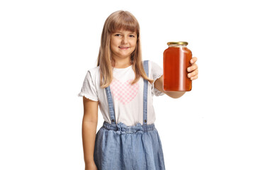 Smiling little girl a jar of natural organic honey