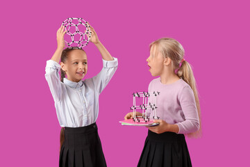 Little classmates in stylish uniform with molecular models on purple background