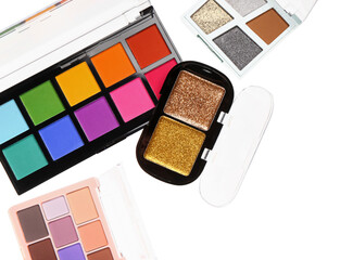 Different palettes of modern bright eyeshadows on white background
