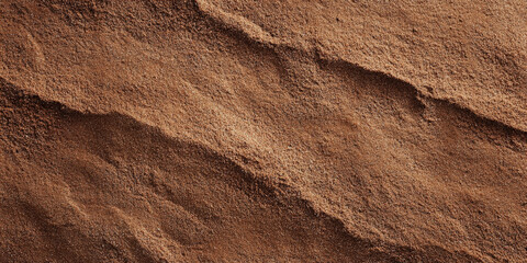 A brown textured surface with a fine, granular texture, similar to fine sand, adding a natural, earthy appearance.