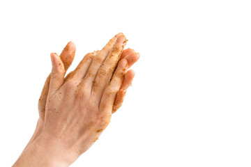 Woman applying natural scrub on her hands against white background, closeup