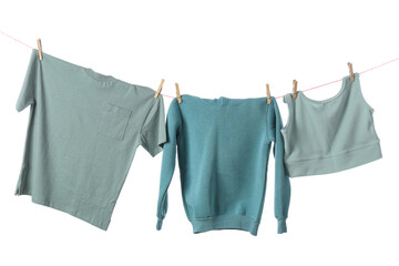 Stylish clean clothes hanging on rope against white background